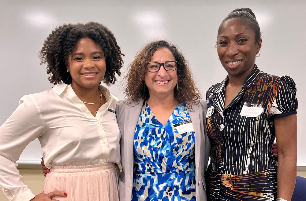 Nicole Komir, Nurse Manager; Evelin La Paz, Manager, Language Services; and Ad Emuwa, MD, MPH smiling and stand side by side at the Cultural Diversity Conference. 